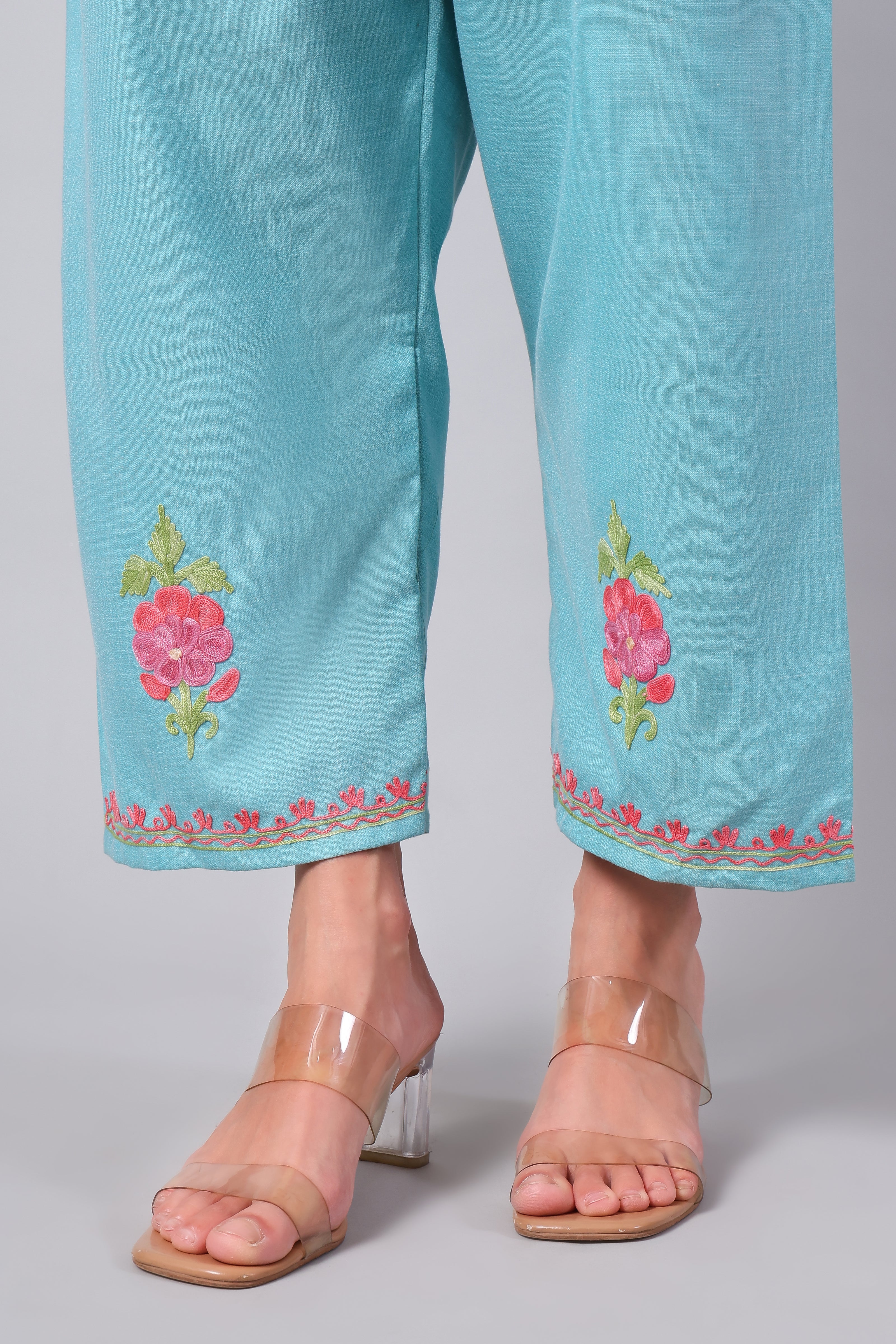 Detailed view of floral Aari embroidery on aqua blue co-ord set pants