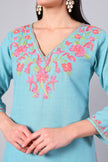 Close-up of coral pink Kashmiri Aari embroidery on aqua blue co-ord set neckline