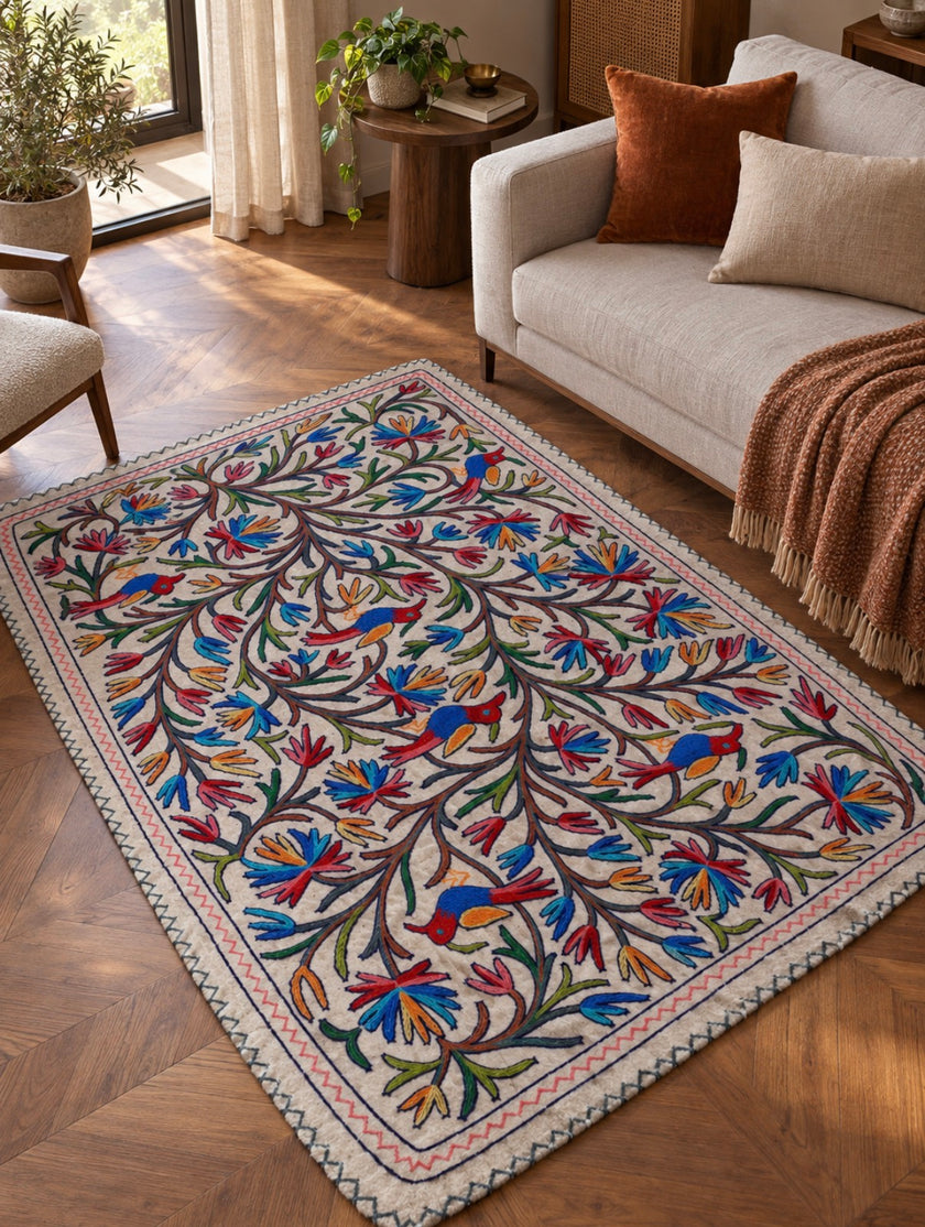 Bagh-e-Nigar Kashmiri Namda rug with colourful floral, vine and bird embroidery on ivory wool base