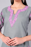 Close-up of rose pink Kashmiri Aari embroidery on grey co-ord set neckline