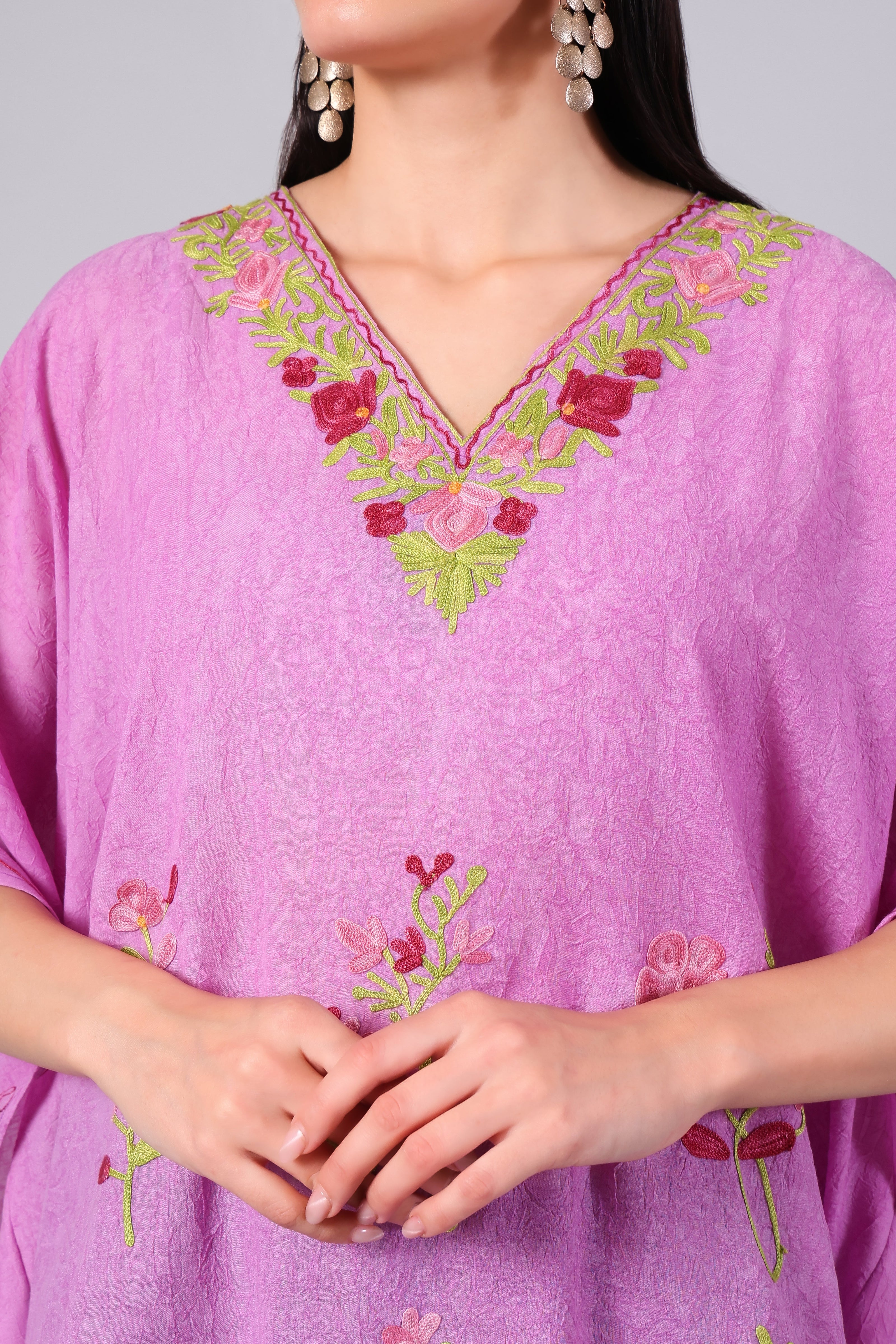 Close-up of multicolour floral Kashmiri Aari embroidery on blush pink kaftan neckline