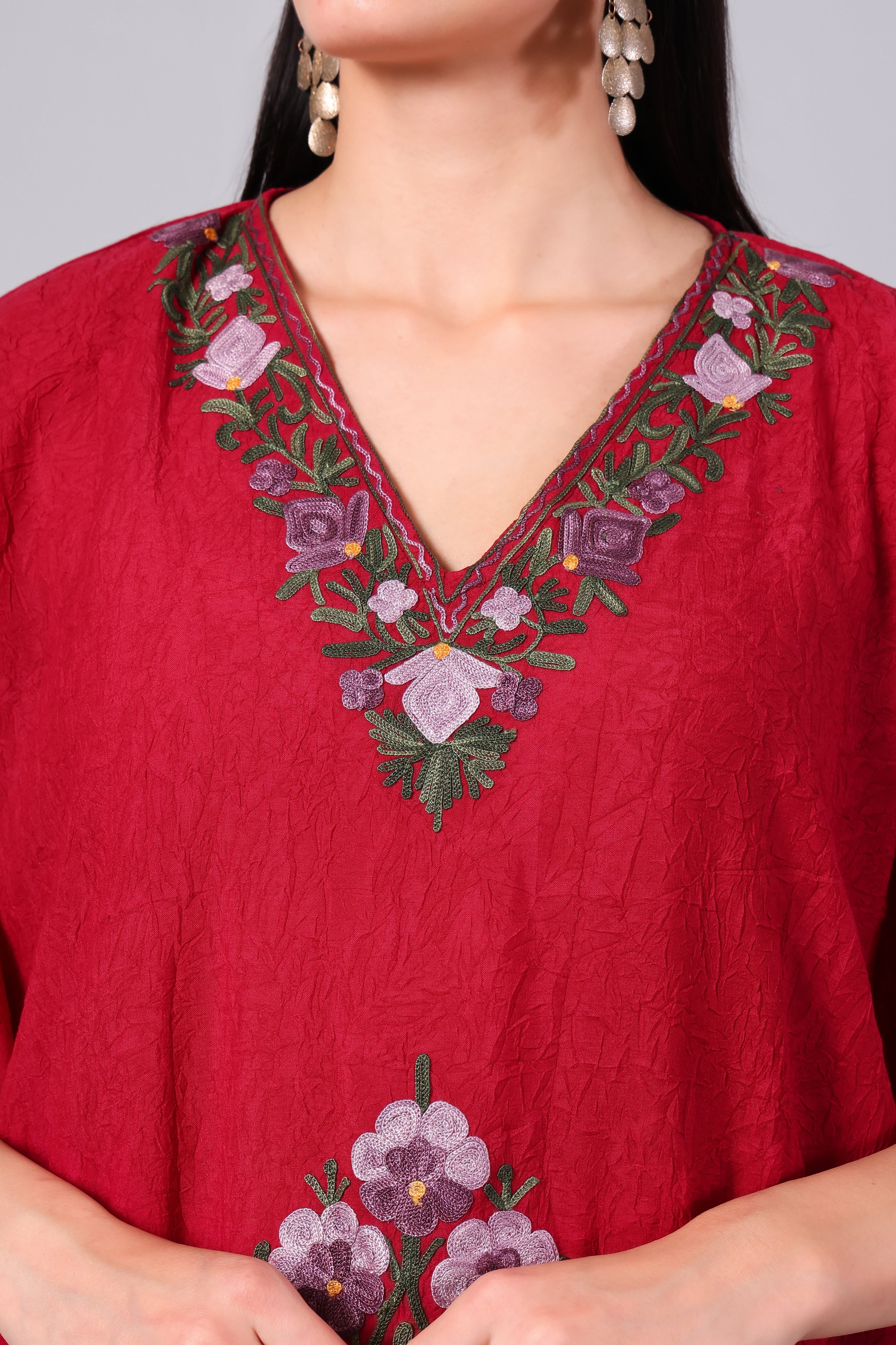 Close-up of multicolour Kashmiri Aari floral embroidery on crimson red kaftan neckline