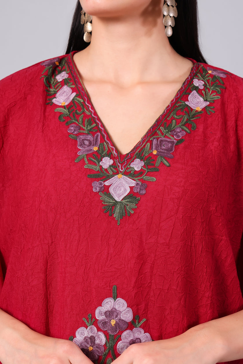Close-up of multicolour Kashmiri Aari floral embroidery on crimson red kaftan neckline