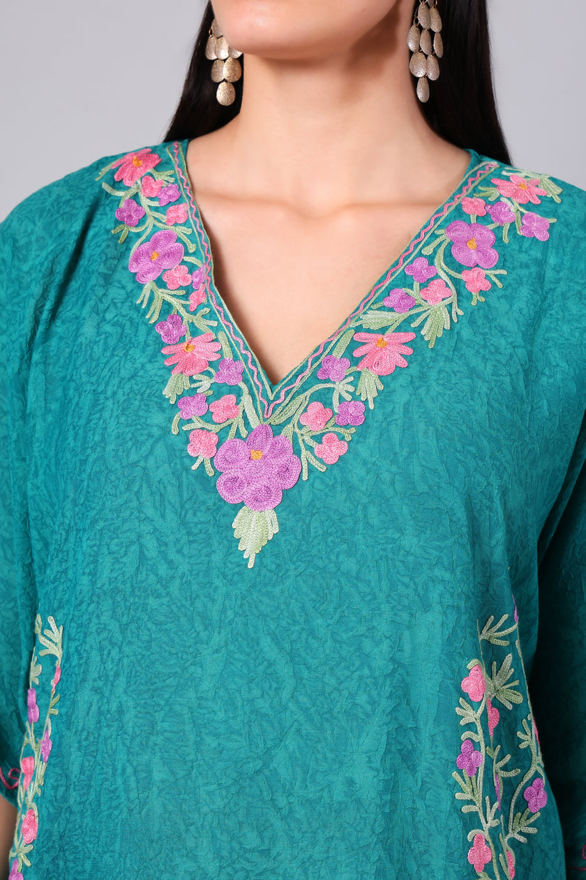 Close-up of multicolour pink floral Kashmiri Aari embroidery on teal kaftan neckline