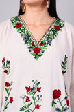 Close-up of red floral Kashmiri Aari embroidery on white kaftan neckline